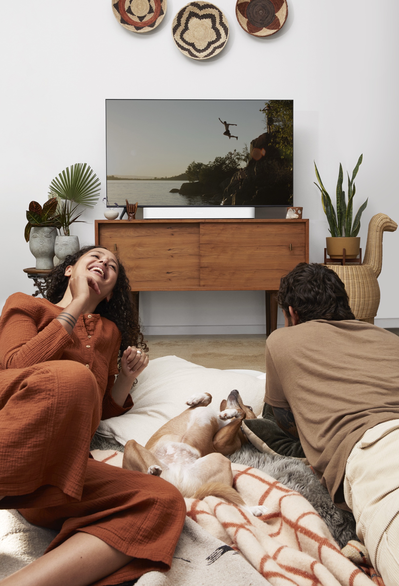 Couple watching TV with Sonos Beam in a compact lounge
