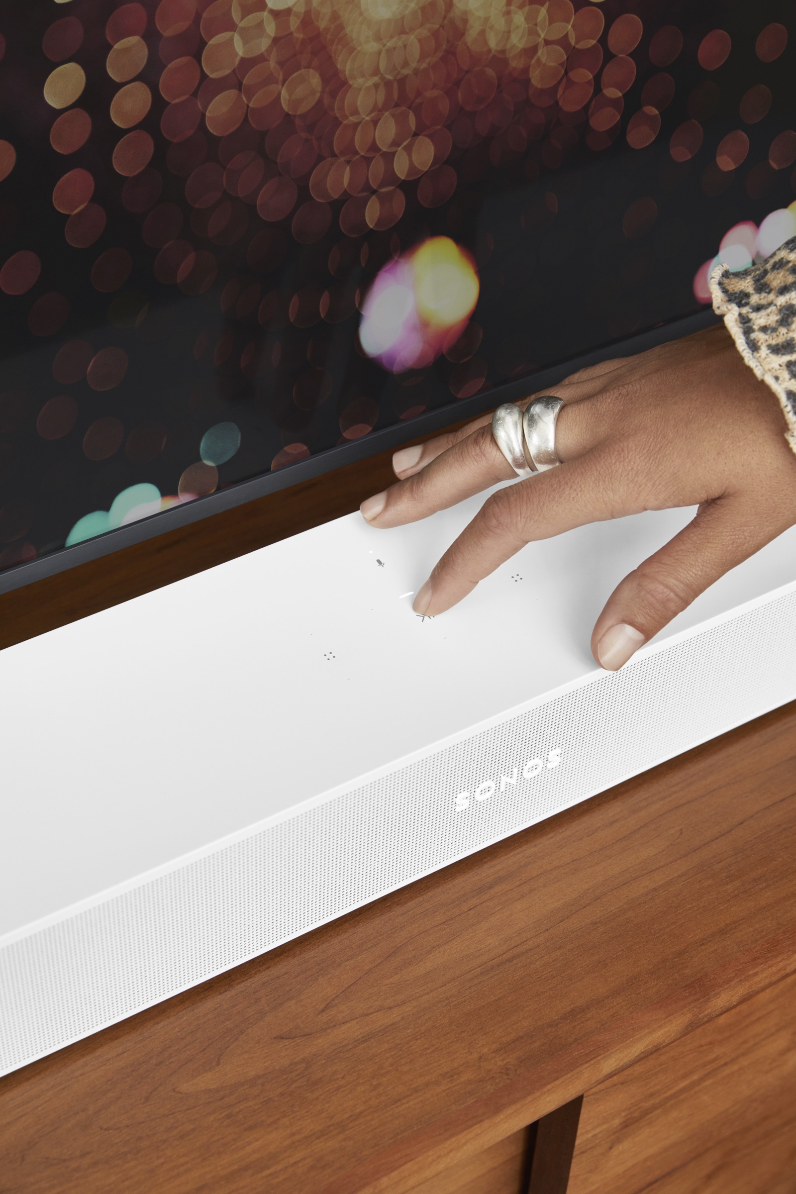 Hand adjusting settings on a Sonos soundbar